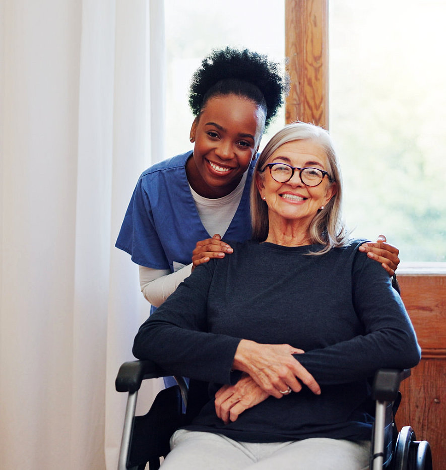 aide and senior woman having a photo together