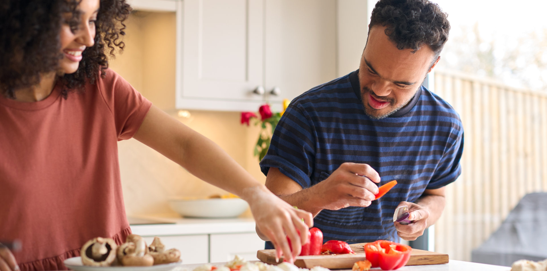 woman and young adult cooking dish