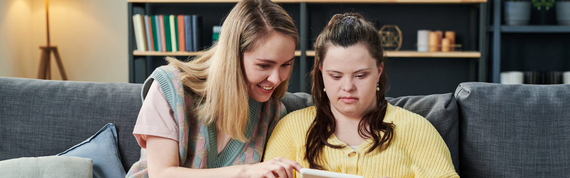 woman and girl using gadget